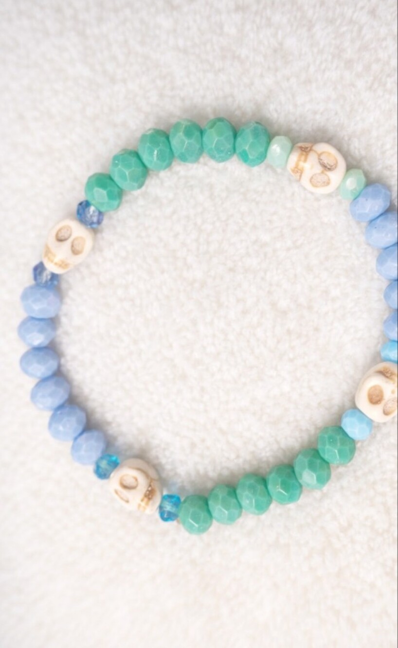 Blue and Green Faceted Bead Stretch Bracelet with Cream Skull Accents
